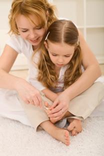 mum and daughter cutting toenails